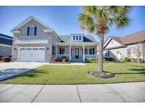 Two-story brick home with front porch at 1206 East Isle Of Palms, Myrtle Beach, SC 29579