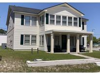 Two-story house with front porch and green lawn at 2202 S Ocean Blvd., North Myrtle Beach, SC 29582