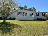 Single-wide mobile home with deck and yard at 12727 Ocean Highway, Pawleys Island, SC 29585