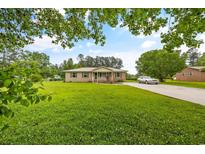 Brick ranch house with a large yard and driveway at 129 Meadowview Rd., Marion, SC 29571