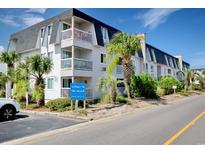Beachfront condo building with balconies and palm trees at 5001 N Ocean Blvd. # 3-E, North Myrtle Beach, SC 29582