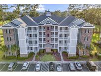 Brick building exterior with balconies and ample parking at 4874 Luster Leaf Circle # 304, Myrtle Beach, SC 29577