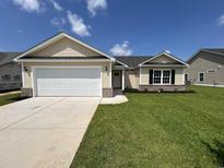 Newly built home with a two car garage and landscaped lawn at 719 Woodside Dr., Conway, SC 29526