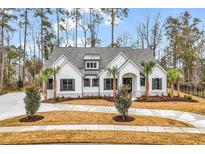 White farmhouse exterior with gray roof, landscaping, and driveway at 2084 Timmerman Rd., Myrtle Beach, SC 29588