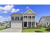 Two-story home with gray siding, white trim, and a two-car garage at 297 Broughton Dr., Myrtle Beach, SC 29579