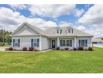 One-story house with gray siding, blue shutters, and a well-manicured lawn at 268 Maple Oak Dr., Conway, SC 29526