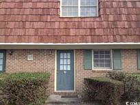 Brick building with a gray door and green shutters at 1025 Carolina Rd. # M-3, Conway, SC 29526