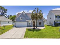 Two-story house with blue siding, palm tree, and driveway at 455 Blackberry Ln., Myrtle Beach, SC 29579