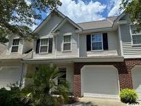 Two-story townhome with attached garage and landscaping at 59-2 Rye Grass Ln. # 2, Pawleys Island, SC 29585