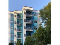 Modern condo building with blue and white exterior at 5001 Little River Rd. # W-110, Myrtle Beach, SC 29577