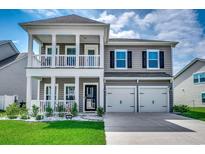 Two story house with gray siding, white trim, and double garage at 780 Harrison Mill St., Myrtle Beach, SC 29579