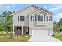 Two-story house with stone accents and a two-car garage at 3327 Moss Bridge Ln., Myrtle Beach, SC 29579