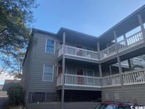 Gray building with multiple balconies and parking area at 107 Toby Ct. # 103-A, North Myrtle Beach, SC 29582