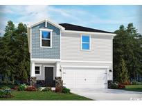 Two-story home with gray siding, a white garage door, and stone accents at 546 Cypress Preserve Circle, Longs, SC 29568