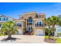 Mediterranean style home with double garage and palm trees at 181 Palmetto Harbour Dr., North Myrtle Beach, SC 29582