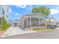 House exterior with porch and landscaping at 6001-5240 S Kings Hwy., Myrtle Beach, SC 29575