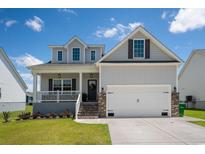 Two-story house with gray siding and brick accents at 606 Antebellum Ln., Georgetown, SC 29440