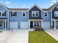 Two-story blue and gray townhouse with a two-car garage at 716 Nw Palm Frond Way # 67, Calabash, NC 28467