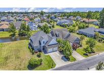 Aerial view of a luxurious house with a large backyard, situated on a waterfront lot at 1312 Ashboro Ct., Myrtle Beach, SC 29579