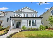 Two-story house with gray siding, white trim, and a landscaped lawn at 219 West Palms Dr., Myrtle Beach, SC 29579