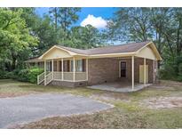 Brick ranch home with carport, mature trees, and a spacious yard at 2183 Highway 544, Conway, SC 29526