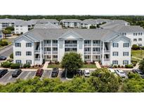 Exterior view of a multi-unit building with ample parking at 901 West Port Dr. # 2118, North Myrtle Beach, SC 29582