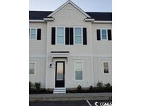 Front view of a two-story townhouse with white siding and black door at 2810 Cook Circle # C, Myrtle Beach, SC 29577