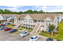 Tan two-story building with parking and landscaping at 221 Portsmith Dr. # 7, Myrtle Beach, SC 29588