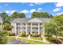 Three-story building with multiple balconies and ample parking at 5040 Windsor Green Way # 302, Myrtle Beach, SC 29579