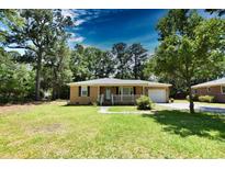 Brick ranch home with a front porch and attached garage at 553 Martin Luther King Rd., Pawleys Island, SC 29585