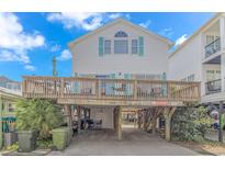 Two-story beach house with a large deck and parking underneath at 6001- 1029 S Kings Hwy., Myrtle Beach, SC 29575