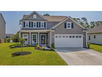 Two-story house with gray siding, white trim, and a two-car garage at 859 Wild Leaf Loop, Conway, SC 29526