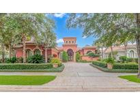 Mediterranean style home with stucco exterior, tile roof, and lush landscaping at 8056 Cortona Dr., Myrtle Beach, SC 29572