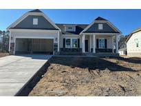 Two-story Craftsman style home with gray siding and stone accents at 537 Honeyhill Loop, Conway, SC 29526