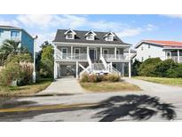 Two-story home with large front porch and driveway at 619 Springs Ave., Pawleys Island, SC 29585