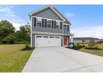 Two-story home with gray siding, white garage door, and landscaping at 1048 Oak Meadow Dr., Conway, SC 29526