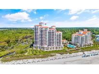 Aerial view of luxurious beachfront condo building with pool at 122 Vista Del Mar Ln. # 2-302, Myrtle Beach, SC 29572