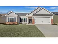 New construction home with brick accents and a two-car garage at 315 Lakota Loop, Longs, SC 29568