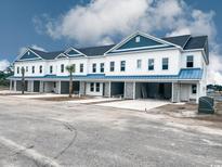 Newly constructed townhouses with white siding, blue trim, and stone accents at 310 Lineback Pl. # 310, Longs, SC 29568