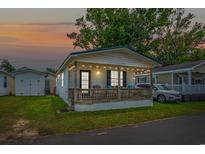 Charming cottage with a porch, string lights, and a yard at 6001-5137 S Kings Hwy., Myrtle Beach, SC 29575