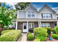 Two-story townhouse with brick facade and landscaping at 1065 Pinwheel Loop # 1065, Myrtle Beach, SC 29577