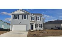 Two-story gray house with white garage door and landscaping at 2628 Riverboat Way, Conway, SC 29526