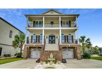 Two-story house with brick facade, double garage, and ornate front door at 153 Palmetto Harbour Dr., North Myrtle Beach, SC 29582