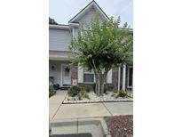 Two-story townhouse with brick and siding exterior, landscaping, and walkway at 1048 Portico Loop # 1048, Myrtle Beach, SC 29577