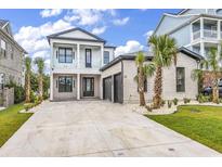 Luxury two-story home with light brick exterior and a three-car garage at 851 Waterton Ave., Myrtle Beach, SC 29579