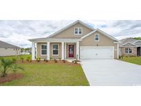 Two-story house with beige siding, red door, and two-car garage at 120 Pampa Dr., Loris, SC 29569