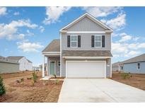 Two story gray house with white garage door at 1075 Flintshire Dr., Myrtle Beach, SC 29579