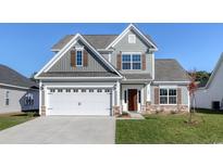 Two-story house with gray siding, white garage door, and brown front door at 308 Happy Valley Dr., Myrtle Beach, SC 29588