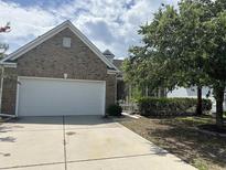 Brick house with a white garage door and well-maintained landscaping at 3609 White Oleander Ct., North Myrtle Beach, SC 29582