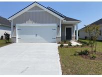 House exterior: one-story home with a white garage door at 782 Cypress Preserve Circle, Longs, SC 29568